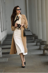 a lady in a white shirt, a white denim skirt and a long trench coat